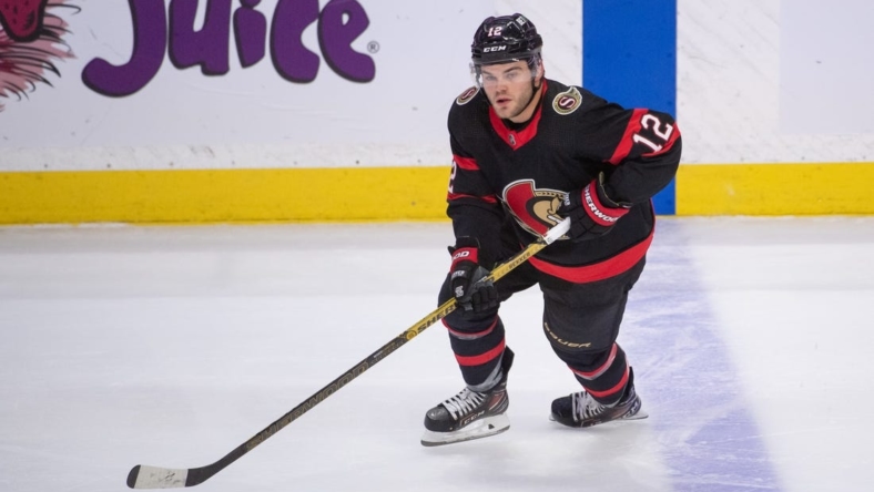 Apr 10, 2023; Ottawa, Ontario, CAN; Ottawa Senators right wing Alex DeBrincat (12) skates with the puck in the third period against the Carolina Hurricanes at the Canadian Tire Centre. Mandatory Credit: Marc DesRosiers-USA TODAY Sports