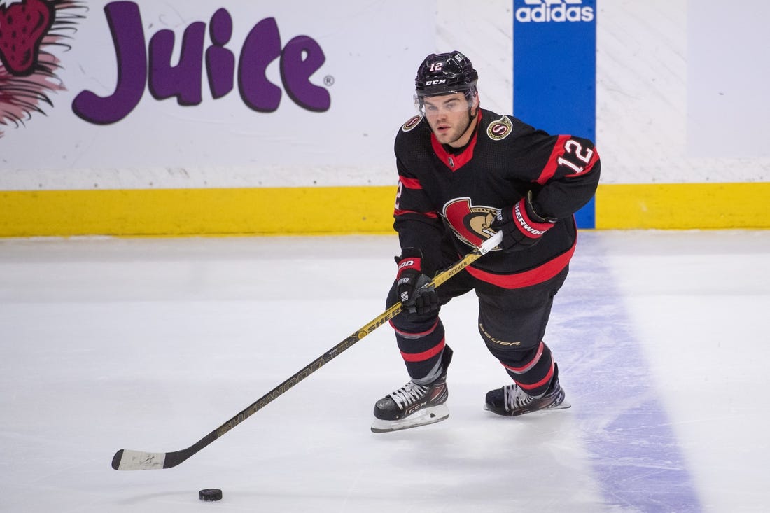 Apr 10, 2023; Ottawa, Ontario, CAN; Ottawa Senators right wing Alex DeBrincat (12) skates with the puck in the third period against the Carolina Hurricanes at the Canadian Tire Centre. Mandatory Credit: Marc DesRosiers-USA TODAY Sports