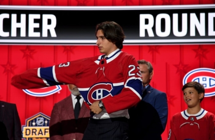 Jun 28, 2023; Nashville, Tennessee, USA; Montreal Canadiens draft pick David Reinbacher puts on his sweater after being selected with the fifth pick in round one of the 2023 NHL Draft at Bridgestone Arena. Mandatory Credit: Christopher Hanewinckel-USA TODAY Sports