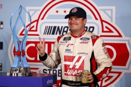 Jul 2, 2023; Chicago, Illinois, USA;  Xfinity Series driver Cole Custer (00) poses with the race trophy after the race was canceled by NASCAR due to flooding for The Loop 121 of the Chicago Street Race. Mandatory Credit: Mike Dinovo-USA TODAY Sports
