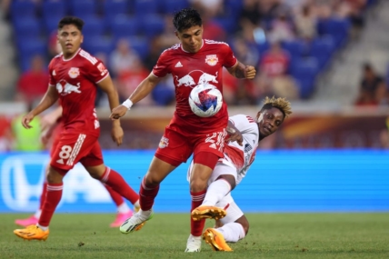Jul 8, 2023; Harrison, New Jersey, USA; New York Red Bulls midfielder Omir Fernandez (21) battles for the ball against New England Revolution forward Latif Blessing (19) during the first half at Red Bull Arena. Mandatory Credit: Vincent Carchietta-USA TODAY Sports