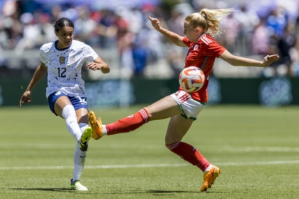 Jul 9, 2023; San Jose, California, USA; United States of America defender Alana Cook (12) passes past Wales midfielder Ceri Holland (7) during the first half at PayPal Park. Mandatory Credit: John Hefti-USA TODAY Sports